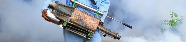 Fumigation technician using a fogger for deep pest treatment in Sarasota, FL